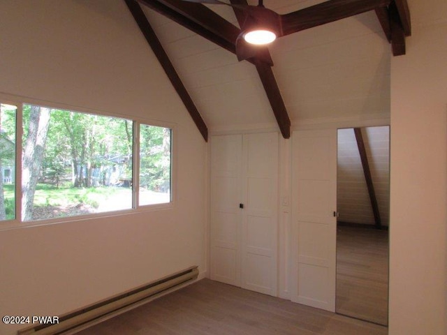 interior space featuring wood-type flooring, lofted ceiling with beams, and a baseboard radiator