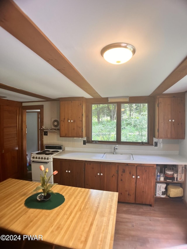 kitchen featuring tasteful backsplash, light hardwood / wood-style flooring, gas range gas stove, and sink