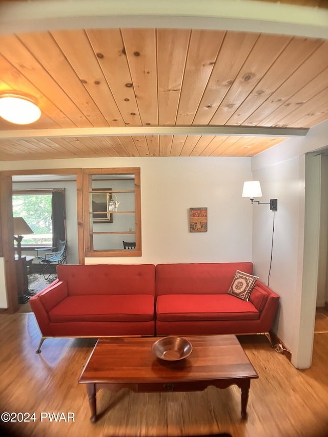 living room featuring beamed ceiling, wood-type flooring, and wooden ceiling