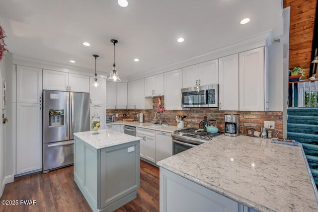 37 Rockpoint Ct, Lake Ariel, PA 18436 - kitchen featuring appliances with stainless steel finishes, light stone counters, backsplash, white cabinetry, and a kitchen island