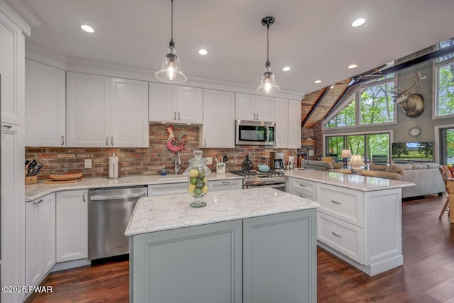 37 Rockpoint Ct, Lake Ariel, PA 18436 - kitchen with appliances with stainless steel finishes, a peninsula, a kitchen island, white cabinetry, and decorative backsplash