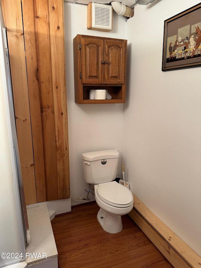 bathroom featuring hardwood / wood-style floors and toilet