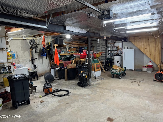 garage with white refrigerator, a garage door opener, and water heater