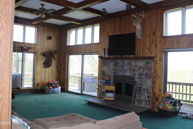 living room featuring carpet, beam ceiling, a healthy amount of sunlight, and coffered ceiling