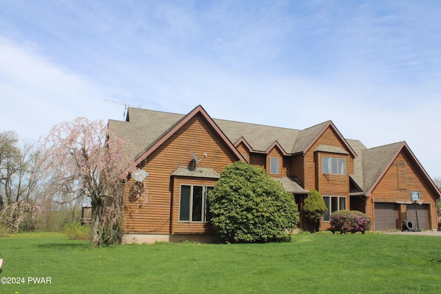 view of front of house featuring a garage and a front lawn