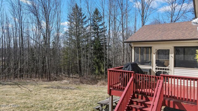 wooden terrace with a sunroom and a yard