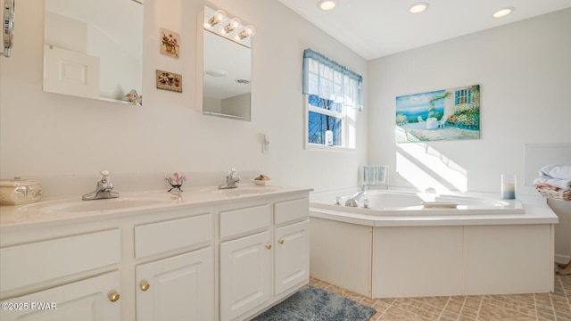 bathroom featuring tile patterned floors, a sink, double vanity, and a bath