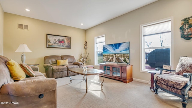 living room with recessed lighting, baseboards, light colored carpet, and visible vents