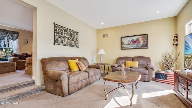 carpeted living area with a wealth of natural light, visible vents, and recessed lighting