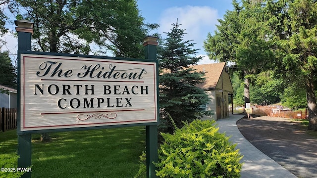 community / neighborhood sign featuring fence