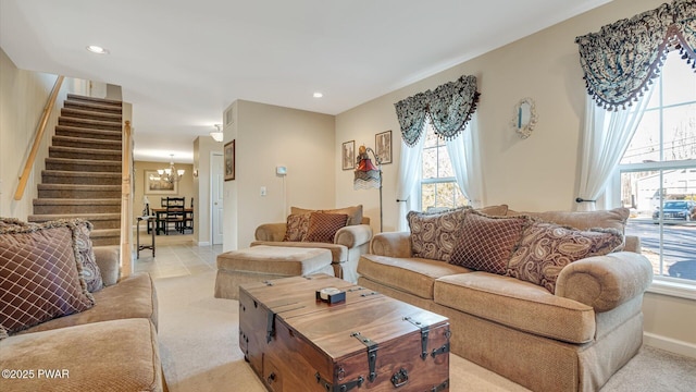 living room featuring recessed lighting, an inviting chandelier, stairway, and light colored carpet