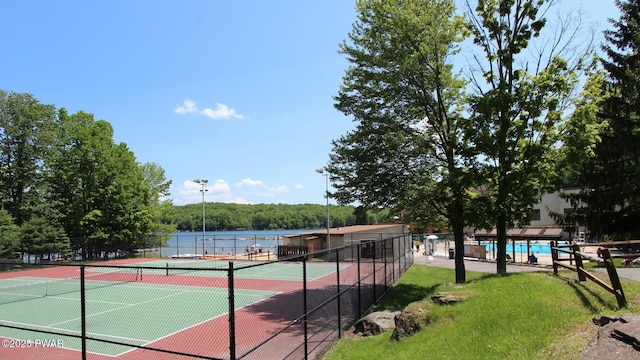 view of tennis court featuring fence