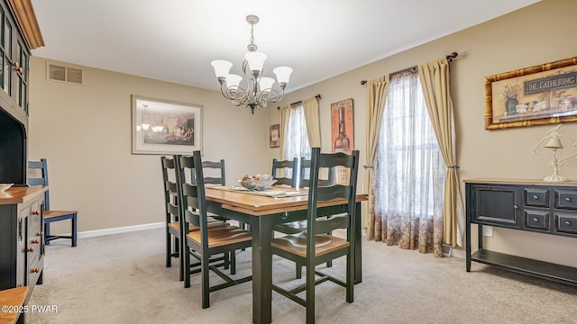 dining room with a notable chandelier, baseboards, light carpet, and visible vents