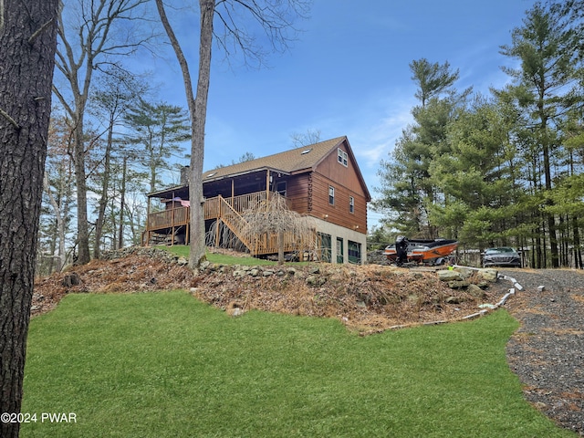 back of house featuring a deck and a yard