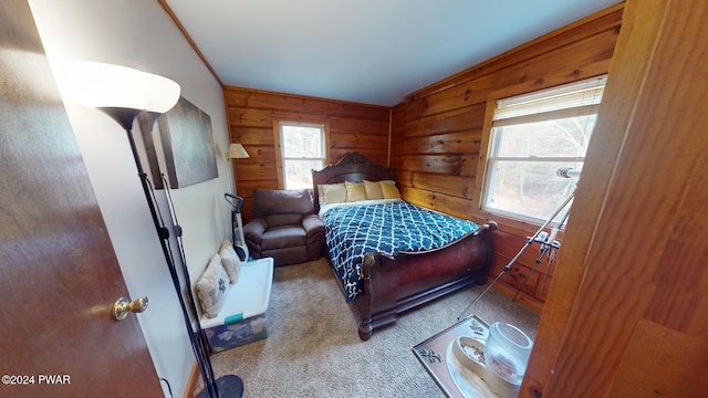 carpeted bedroom featuring multiple windows, wooden walls, and crown molding