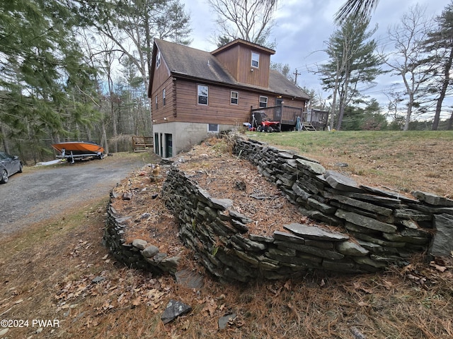 view of home's exterior featuring a wooden deck