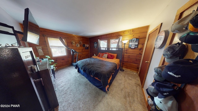 bedroom featuring wood walls and light carpet