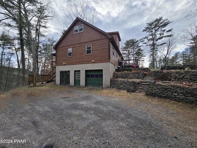 view of side of property featuring a deck and a garage