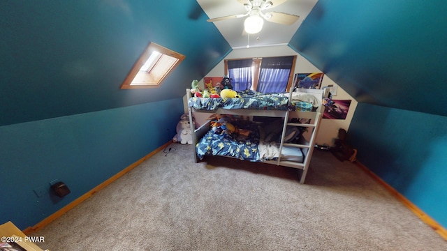 bedroom featuring ceiling fan, carpet floors, and lofted ceiling with skylight