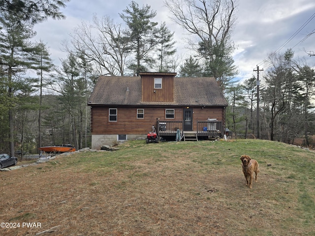 back of property featuring a yard and a deck