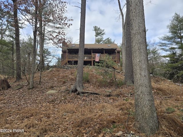 rear view of house featuring a deck