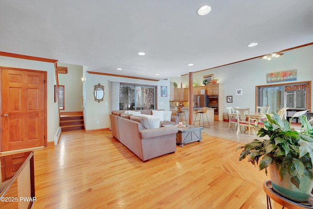 living area with stairway, crown molding, and recessed lighting