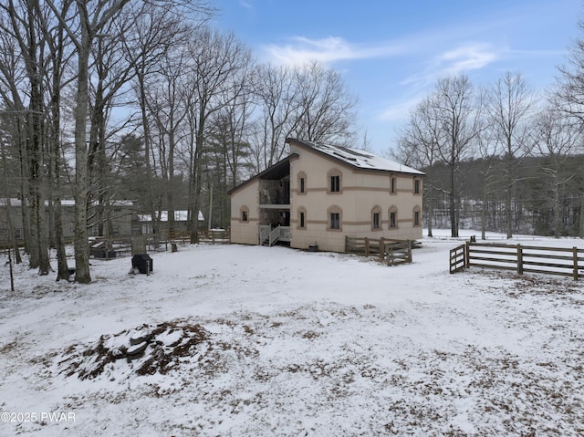 view of snow covered rear of property