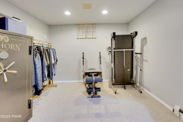 exercise room with a baseboard heating unit, recessed lighting, visible vents, and baseboards