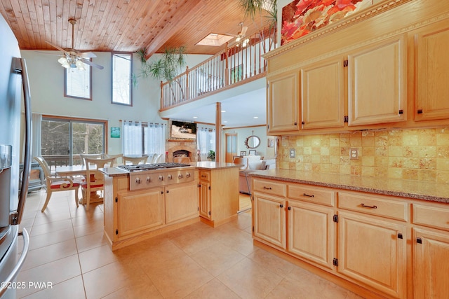 kitchen with wooden ceiling, ceiling fan, tasteful backsplash, and a center island