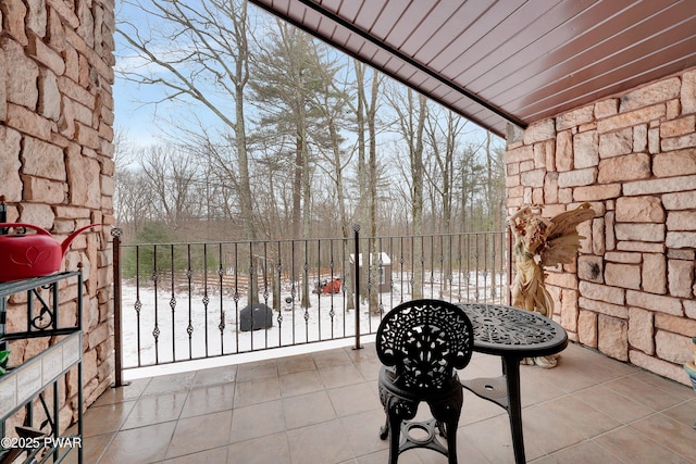 view of snow covered back of property