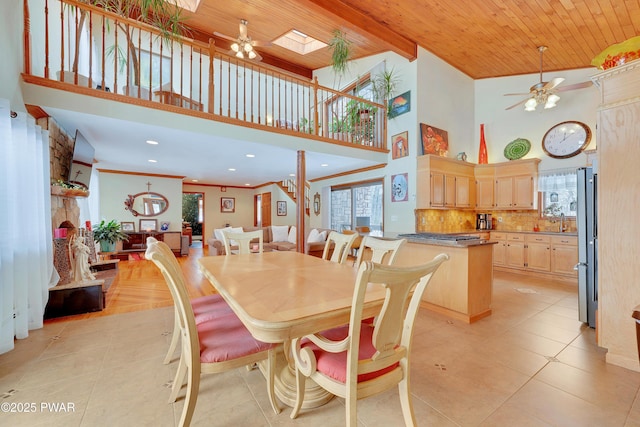 dining space with a healthy amount of sunlight, wood ceiling, ornamental molding, and a ceiling fan