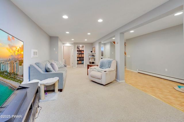 living room with baseboards, baseboard heating, visible vents, and recessed lighting