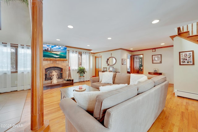 living room featuring crown molding, light wood finished floors, recessed lighting, a baseboard radiator, and a tiled fireplace