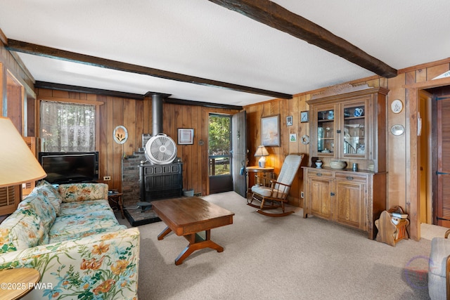 71 Boulder Point Rd, Lakeville, PA 18438 - living room with a wood stove, light colored carpet, beamed ceiling, and wood walls