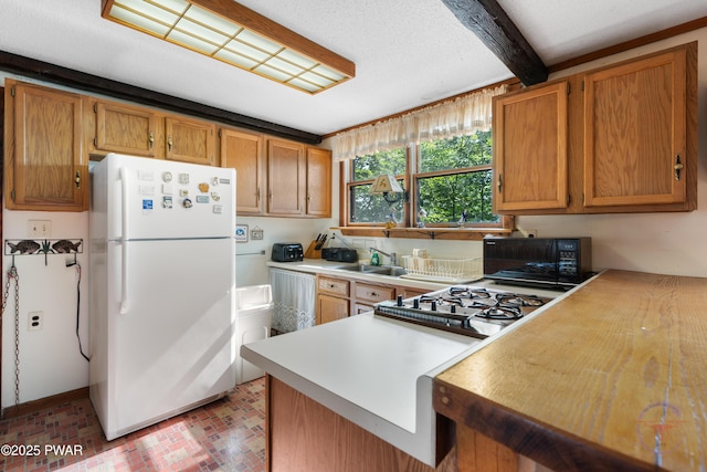 71 Boulder Point Rd, Lakeville, PA 18438 - kitchen featuring freestanding refrigerator, black microwave, brick patterned flooring, light countertops, and brown cabinets