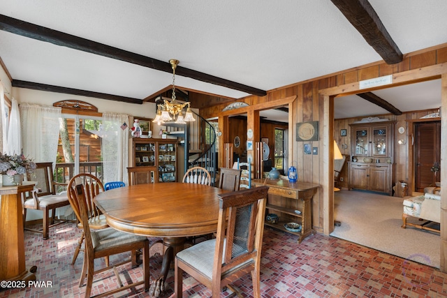 71 Boulder Point Rd, Lakeville, PA 18438 - dining room with a chandelier, wood walls, beam ceiling, brick patterned floors, and stairs