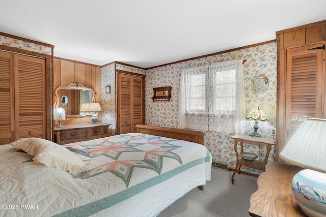 71 Boulder Point Rd, Lakeville, PA 18438 - bedroom featuring crown molding, wallpapered walls, two closets, and carpet floors