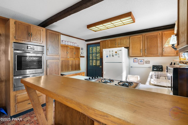 71 Boulder Point Rd, Lakeville, PA 18438 - kitchen featuring freestanding refrigerator, under cabinet range hood, brick patterned floors, light countertops, and brown cabinets