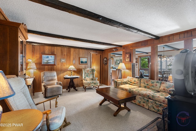 71 Boulder Point Rd, Lakeville, PA 18438 - carpeted living room featuring a textured ceiling, beam ceiling, wood walls, and a chandelier
