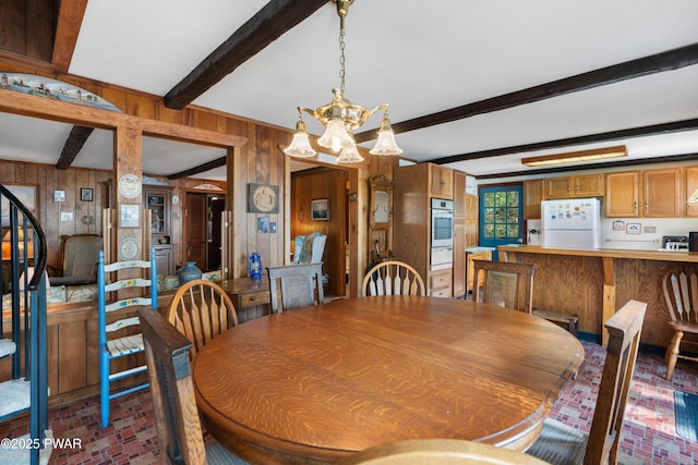 71 Boulder Point Rd, Lakeville, PA 18438 - dining area with brick floors, wooden walls, a chandelier, beamed ceiling, and stairway