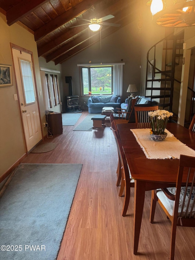 112 Ewe Ln, Tobyhanna, PA 18466 - dining space featuring wood finished floors, a wood stove, stairway, a wood ceiling with exposed beams, and ceiling fan