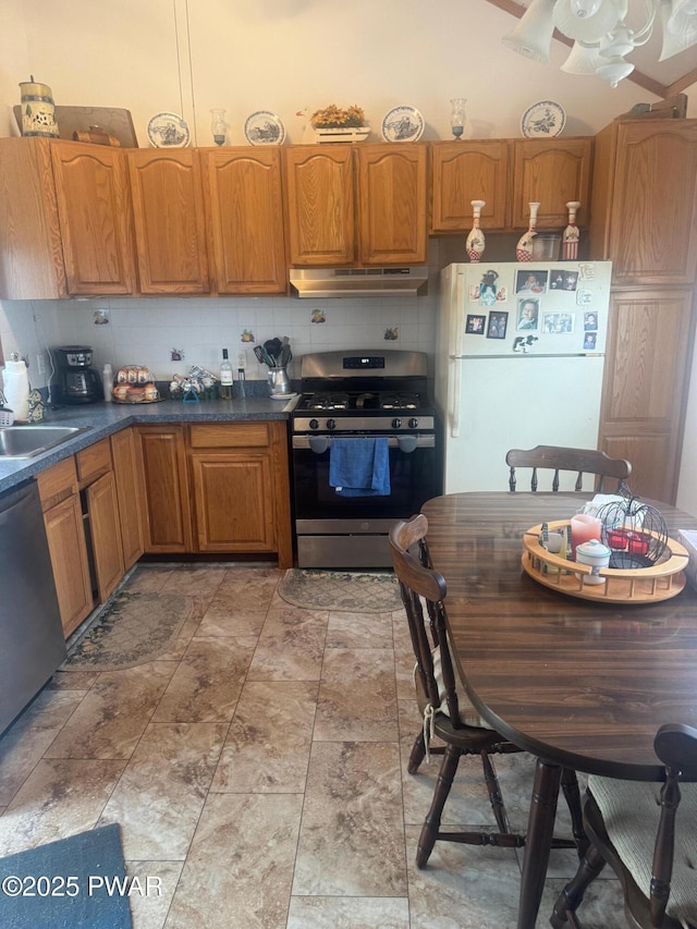 112 Ewe Ln, Tobyhanna, PA 18466 - kitchen with stainless steel appliances, under cabinet range hood, tasteful backsplash, and brown cabinetry