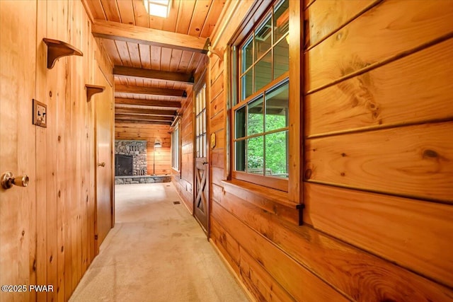 349 Starlight Lake Rd, Starlight, PA 18461 - corridor featuring wooden ceiling with exposed beams, wooden walls, and light carpet