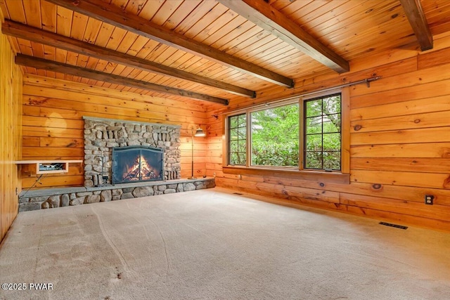 349 Starlight Lake Rd, Starlight, PA 18461 - unfurnished living room featuring wooden walls, wooden ceiling with exposed beams, carpet floors, and a fireplace