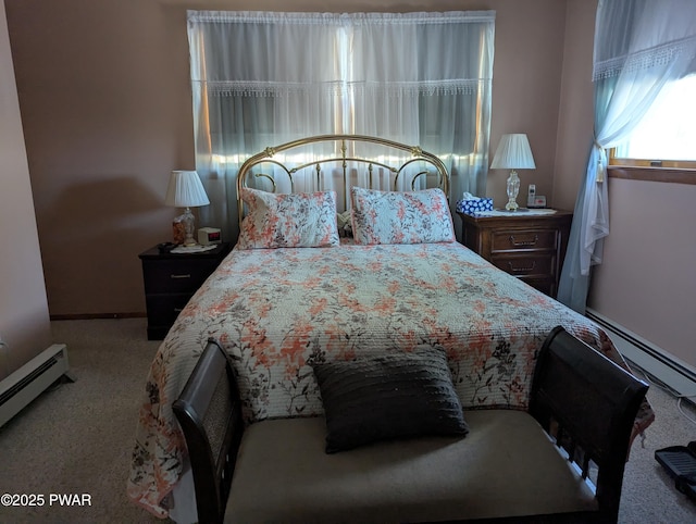 bedroom featuring a baseboard heating unit and light colored carpet