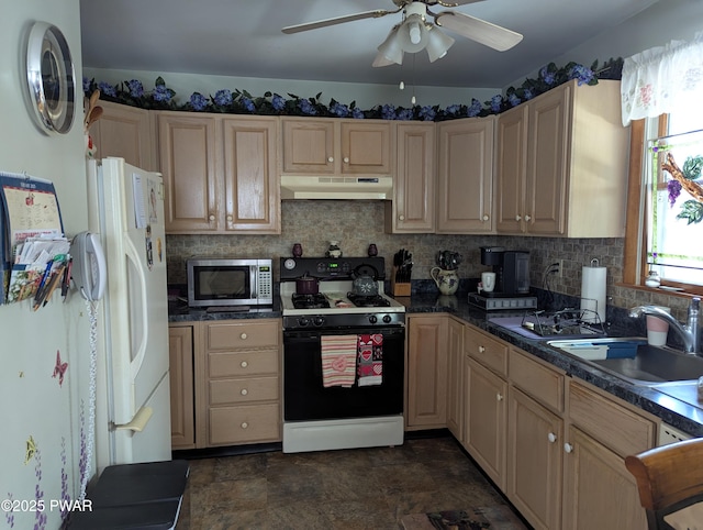 kitchen with black gas range, dark countertops, stainless steel microwave, under cabinet range hood, and a sink