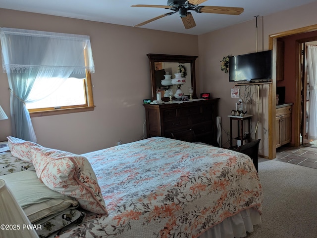 bedroom featuring a ceiling fan and light colored carpet