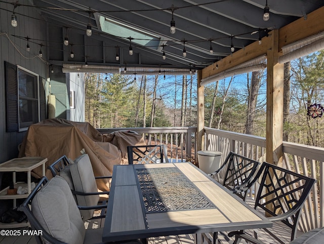 wooden terrace with outdoor dining space