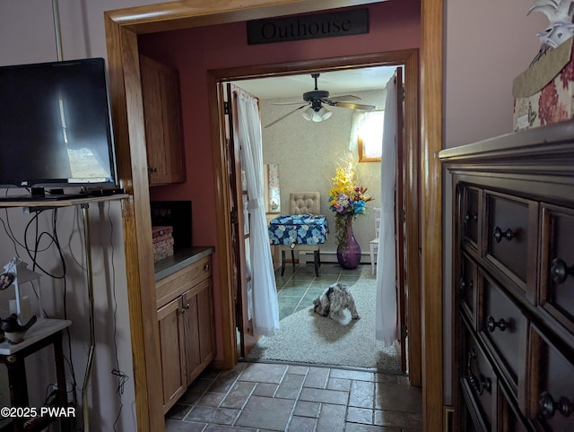 interior space featuring carpet floors, stone tile flooring, and baseboards