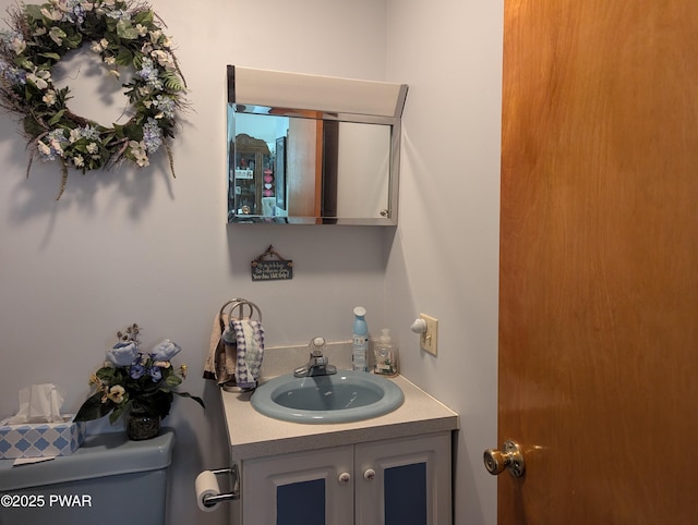 half bathroom with toilet and vanity